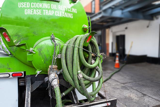 a service truck pumping grease from a restaurant's grease trap in Belle Glade, FL